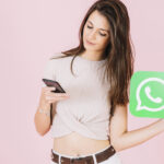 beautiful-young-woman-holding-whatsapp-icon-using-mobile-phone