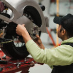 Man fixing a motorcycle in a modern workshop