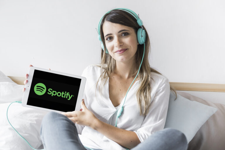 young-woman-holding-tablet-with-spotify-app