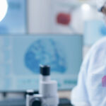 Closeup of scientist researcher doctor holding medical slide analyzing blood sample