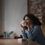 medium-shot-woman-with-book-coffee-shop