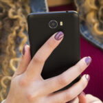young-urban-woman-looking-smartphone